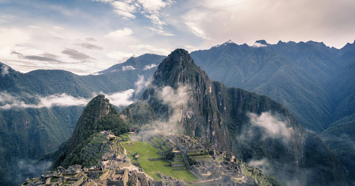 Ancient stone ruins of Machu Picchu citadel with dramatic Andean mountain peaks in the background